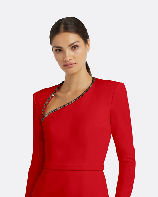 Detail view of woman wearing a red dress with a white background