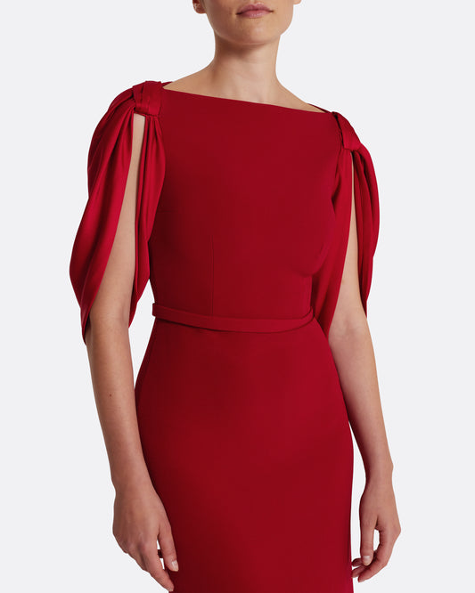 Boat neck gown with fluid draped sleeves in CHERRY RED ON AZALEA RED